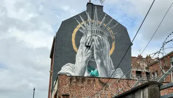 A new mural in France shows the Statue of Liberty covering her eyes in a swipe at Trump
